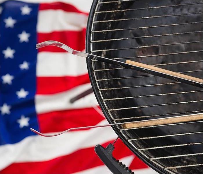 A BBQ grill is ready for use with an American flag as a backdrop in Clarksdale, MS