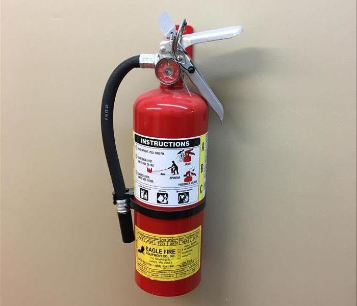 Fire extinguisher hanging on wall